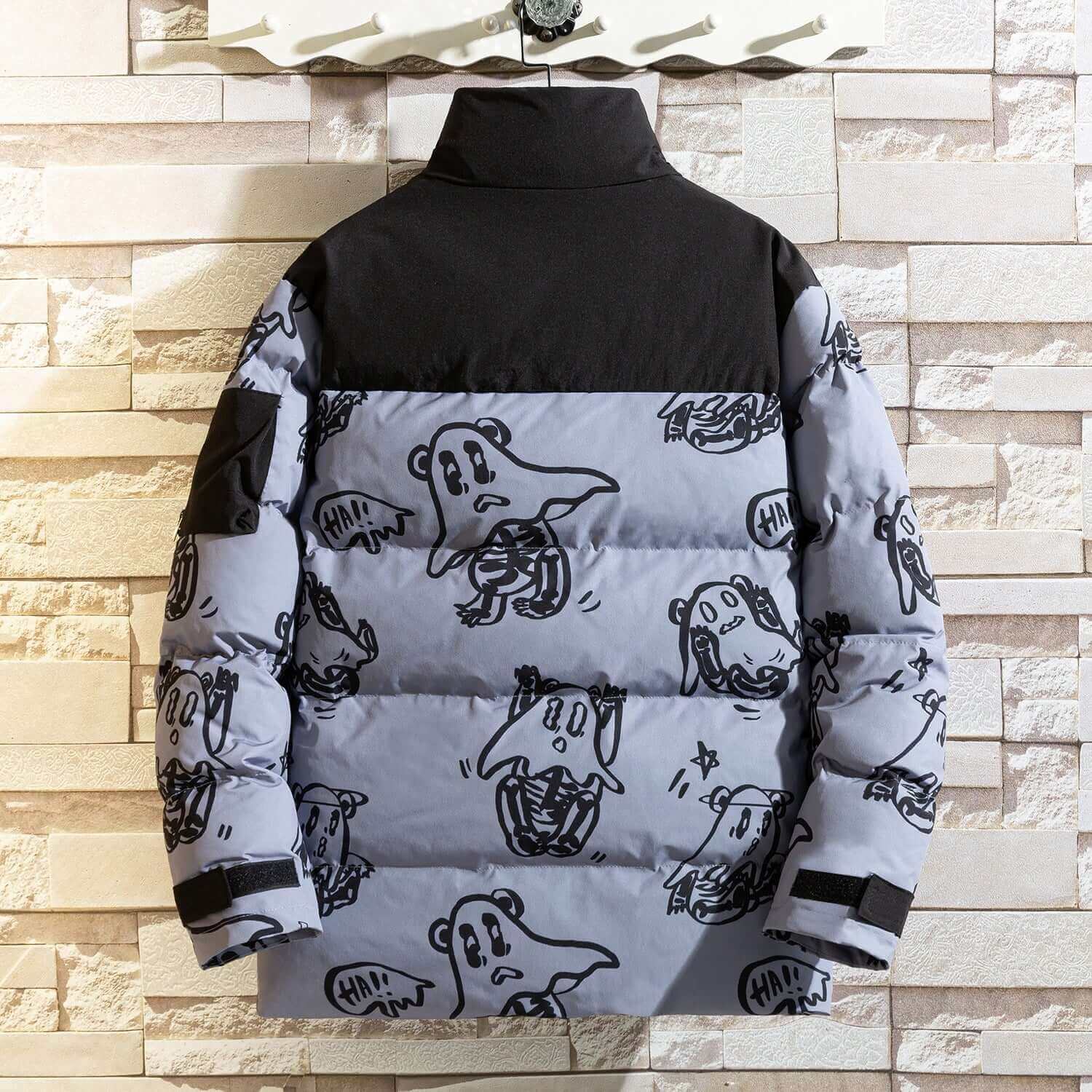 Back view of a Saint Vouge men's fashion puffer jacket with playful ghost illustrations on a gray background.